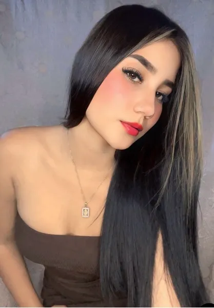 Young woman looking at the camera in a softly lit portrait