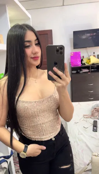 Young woman with long dark hair smiling during a mobile video chat